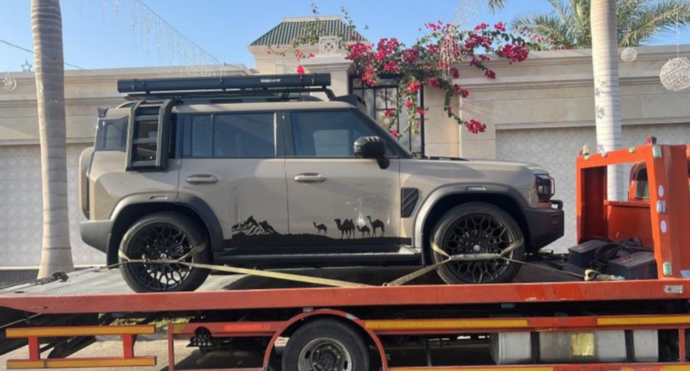 Tow truck transporting an SUV